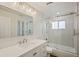 Bright bathroom featuring a sleek vanity, a modern glass-enclosed shower over tub, and contemporary fixtures at 2170 W Warren Ave, Englewood, CO 80110