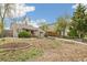 Traditional home with mature trees, a red front door, and a well-kept lawn at 2170 W Warren Ave, Englewood, CO 80110