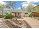 Charming home featuring a red front door, rock landscaping, and a cozy front porch at 2170 W Warren Ave, Englewood, CO 80110