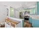 Modern kitchen featuring stylish mint cabinets, stainless steel appliances, and a functional layout at 2170 W Warren Ave, Englewood, CO 80110