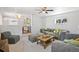 Bright living room with comfortable seating, neutral tones, and a view of the adjacent dining area at 2170 W Warren Ave, Englewood, CO 80110