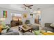 Comfortable living room with ample seating, a ceiling fan, and a view to the entryway at 2170 W Warren Ave, Englewood, CO 80110
