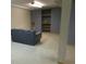 Finished basement with comfortable seating area and built-in shelving at 11710 Elk Head Range Rd, Littleton, CO 80127