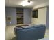 Finished basement with blue accent wall, open shelving, and a comfortable couch at 11710 Elk Head Range Rd, Littleton, CO 80127