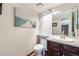 Compact bathroom with a single sink vanity and modern art at 11710 Elk Head Range Rd, Littleton, CO 80127