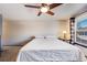 Cozy bedroom featuring a ceiling fan, a window, carpet flooring, and a comfortable bed at 11710 Elk Head Range Rd, Littleton, CO 80127