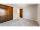 Spacious bedroom features carpet floors, doors to a closet, and a neutral paint color at 11710 Elk Head Range Rd, Littleton, CO 80127
