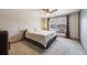 Comfortable bedroom features carpet floors, a fan, a large bed, and a window for natural light at 11710 Elk Head Range Rd, Littleton, CO 80127