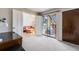 Spacious bedroom with access to a patio and a glimpse into the living area at 11710 Elk Head Range Rd, Littleton, CO 80127