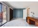 Bright bedroom with sliding glass doors and a modern wooden desk at 11710 Elk Head Range Rd, Littleton, CO 80127