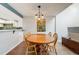 Stylish dining room with hardwood floors and a peek into the modern kitchen at 11710 Elk Head Range Rd, Littleton, CO 80127