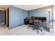 Spacious office with blue accent wall, built-in shelves, computer, and an expansive desk with rolling chair at 11710 Elk Head Range Rd, Littleton, CO 80127