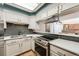 Modern kitchen with stainless steel appliances, stylish backsplash and skylight at 11710 Elk Head Range Rd, Littleton, CO 80127