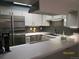 Modern kitchen featuring stainless steel appliances, white cabinets, and a dark subway tile backsplash at 11710 Elk Head Range Rd, Littleton, CO 80127
