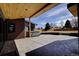 Backyard patio with a hot tub, wood ceiling and wood accent wall at 8900 W Hampden Ave, Denver, CO 80227