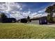Large lot with home and garage on a bright, sunny day at 8900 W Hampden Ave, Denver, CO 80227