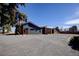 Modern home exterior with stone accents, high ceilings and large driveway at 8900 W Hampden Ave, Denver, CO 80227