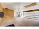 Spacious garage with white walls, wood accent wall and a large garage door at 8900 W Hampden Ave, Denver, CO 80227