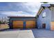 Two modern garages with wood doors and blue/grey exterior at 8900 W Hampden Ave, Denver, CO 80227