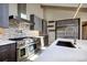 Modern kitchen with stainless steel appliances, and quartz counters at 8900 W Hampden Ave, Denver, CO 80227