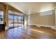 Sun-lit room with hardwood flooring, large sliding glass doors leading to the patio at 8900 W Hampden Ave, Denver, CO 80227