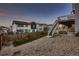 Backyard showing the deck with stairs, privacy fence, and low maintenance landscaping at 17203 Birds Foot Ave, Parker, CO 80134