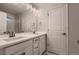 Modern bathroom featuring double sinks, quartz countertops, and a large mirror at 17203 Birds Foot Ave, Parker, CO 80134