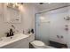 Bathroom featuring a shower with glass doors, modern fixtures, and a sleek vanity at 17203 Birds Foot Ave, Parker, CO 80134
