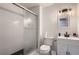 Bathroom featuring a glass shower, white tiling, and modern fixtures at 17203 Birds Foot Ave, Parker, CO 80134