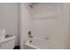 Modern bathroom featuring a shower-tub combination with white tiles at 17203 Birds Foot Ave, Parker, CO 80134