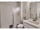 Clean bathroom featuring a shower, single vanity with white countertops, framed mirror, and modern finishes at 17203 Birds Foot Ave, Parker, CO 80134