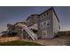 Rear exterior showcasing a multi-story home with a deck, stairs and low maintenance landscaping at 17203 Birds Foot Ave, Parker, CO 80134