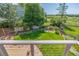 A tiered yard with lush green grass and a rock water feature as seen from the balcony at 1324 Shadow Mountain Dr, Highlands Ranch, CO 80126