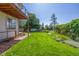A well-manicured lawn and mature landscaping create a private oasis in this backyard at 1324 Shadow Mountain Dr, Highlands Ranch, CO 80126