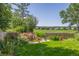 The backyard features a rock waterfall, lush grass, and an eye-pleasing landscape design at 1324 Shadow Mountain Dr, Highlands Ranch, CO 80126