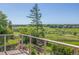 Beautiful backyard view from the deck with green grass and clear sky at 1324 Shadow Mountain Dr, Highlands Ranch, CO 80126