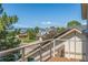 Balcony view of neighborhood homes framed by trees and a clear blue sky at 1324 Shadow Mountain Dr, Highlands Ranch, CO 80126