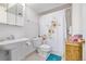 Bright bathroom with a modern sink, toilet, and shower adorned with a decorative floral shower curtain at 1324 Shadow Mountain Dr, Highlands Ranch, CO 80126