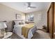 Bright bedroom with a comfortable bed, a window with plantation shutters, and tasteful decor at 1324 Shadow Mountain Dr, Highlands Ranch, CO 80126