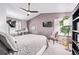 Stylish bedroom featuring a ceiling fan, television, and a comfortable, inviting aesthetic at 1324 Shadow Mountain Dr, Highlands Ranch, CO 80126