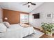 Inviting bedroom with hardwood floors, a cozy bed, a window with shutters, and neutral decor at 1324 Shadow Mountain Dr, Highlands Ranch, CO 80126