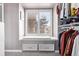 Organized walk-in closet with custom storage solutions and a window seat with a view at 1324 Shadow Mountain Dr, Highlands Ranch, CO 80126