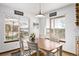 Bright dining room with scenic views and a wooden table and chairs at 1324 Shadow Mountain Dr, Highlands Ranch, CO 80126