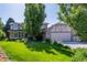 Charming two-story home with lush lawn, mature trees, and a spacious two car garage at 1324 Shadow Mountain Dr, Highlands Ranch, CO 80126