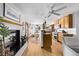 Open-concept kitchen featuring wood cabinets, stainless steel appliances, and a cozy breakfast bar at 1324 Shadow Mountain Dr, Highlands Ranch, CO 80126