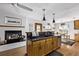 Well-equipped kitchen with a breakfast bar, fireplace, and plenty of counter space at 1324 Shadow Mountain Dr, Highlands Ranch, CO 80126