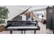 Bright living room features an upright grand piano, natural light, and calming decor at 1324 Shadow Mountain Dr, Highlands Ranch, CO 80126