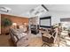 Comfortable living room with wood floors, stone fireplace, a large media screen, and cozy furniture at 1324 Shadow Mountain Dr, Highlands Ranch, CO 80126