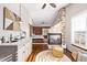 Open main bedroom featuring stone fireplace, vaulted ceilings, sitting area, and sink with cabinets at 1324 Shadow Mountain Dr, Highlands Ranch, CO 80126