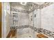 Contemporary shower with tiled walls, a glass door, built-in shelving, and bench seating at 1324 Shadow Mountain Dr, Highlands Ranch, CO 80126